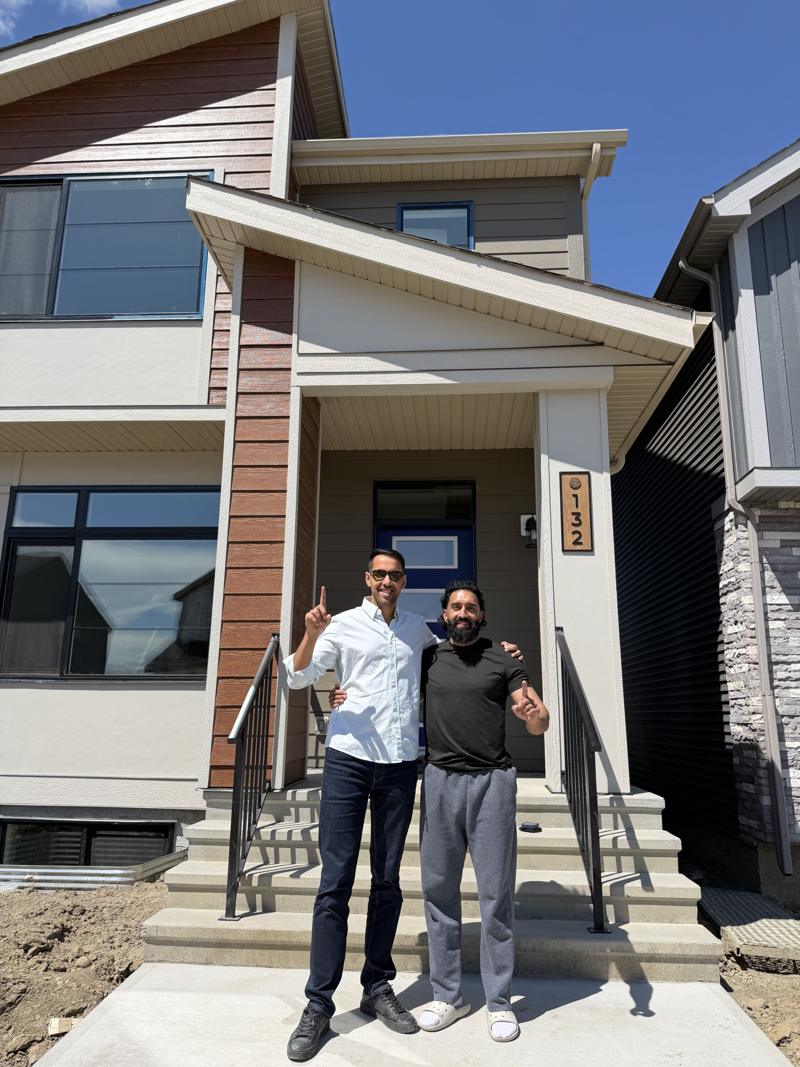 Jaskaran with a buyer outside his new home
