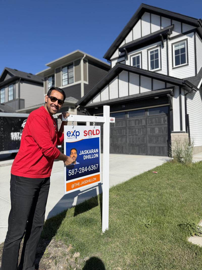 Jaskaran adding a SOLD rider to his sign